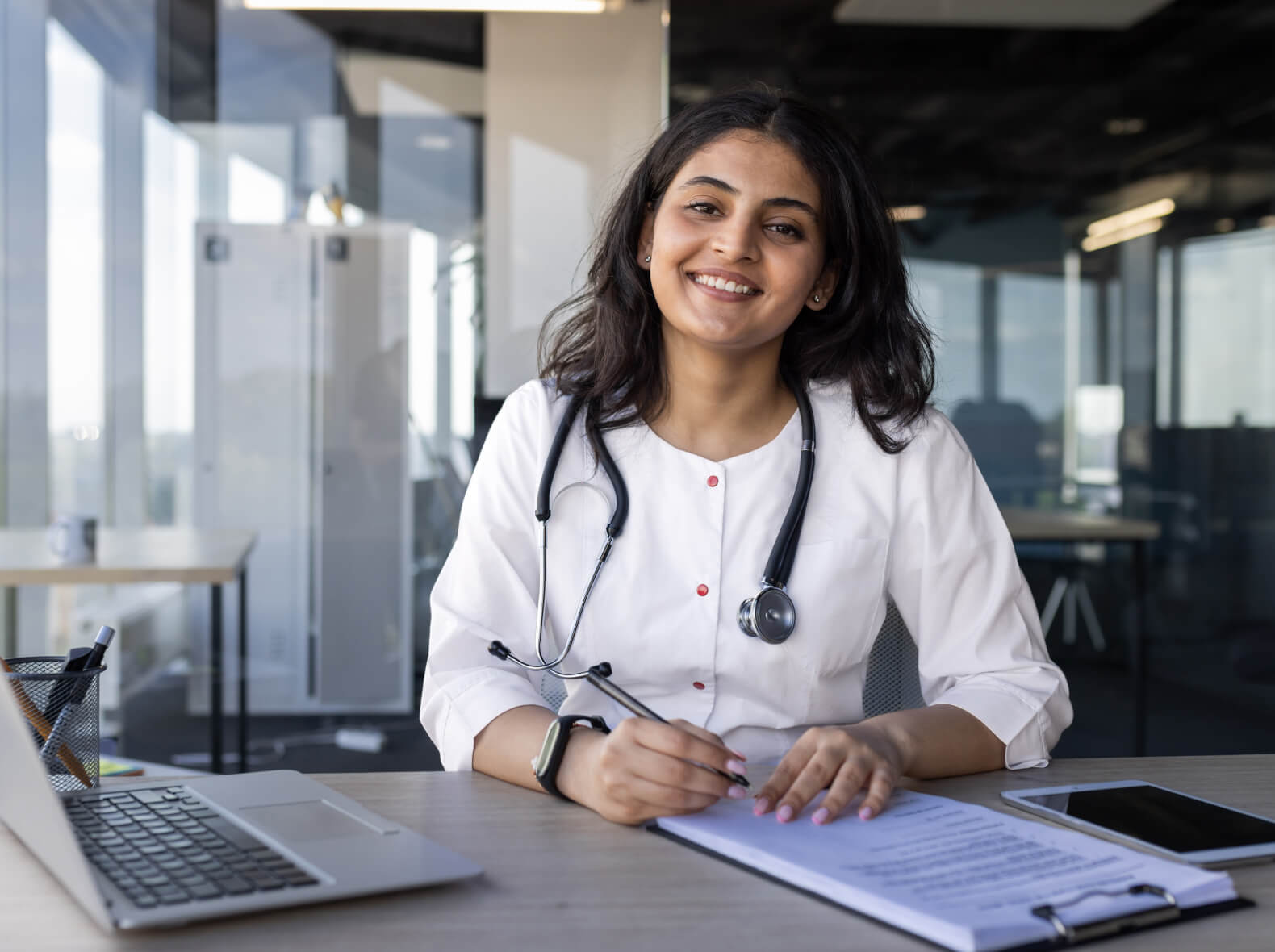 GP at laptop writing documents)