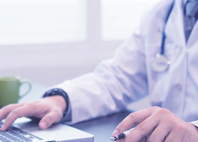 An image showing a doctor working on a desktop